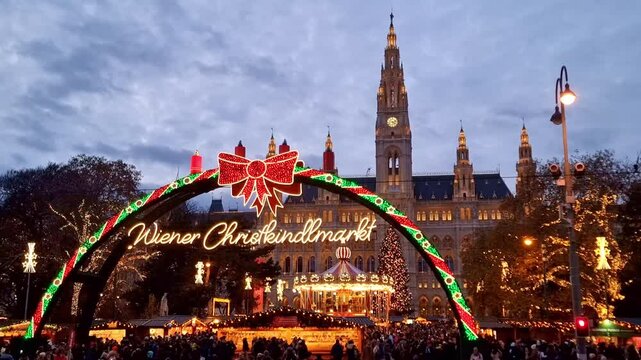 Famous traditional Christmas market (Christkindlmarkt) in front of the City hall during winter holidays, in Vienna, Austria. 4K