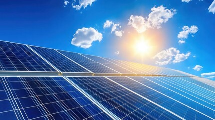 Bright Sun Over Solar Panels with Clear Blue Sky and Clouds