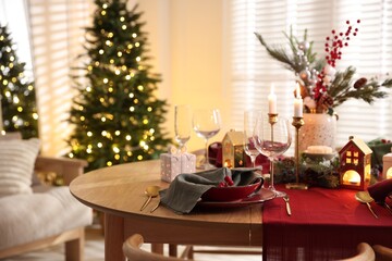 Christmas table setting with stylish dishware and festive decor indoors