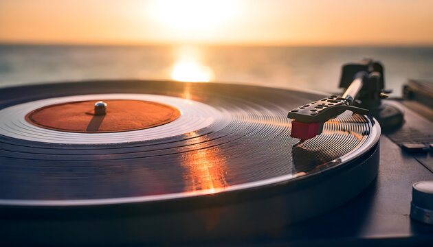 Glimmers of sunlight reflect on a vinyl record as the delicate needle smoothly moves through its grooves, creating melodies that echo the calmness of the approaching dusk by the water