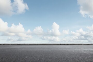 Empty asphalt road under a partly cloudy blue sky. (2)