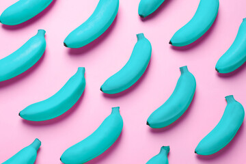 Light blue bananas on pink background, top view