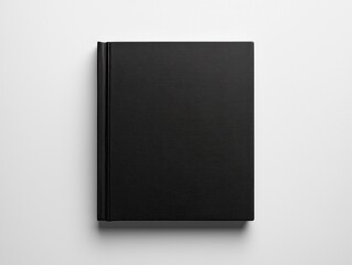 Black hardcover book mockup lying on white table