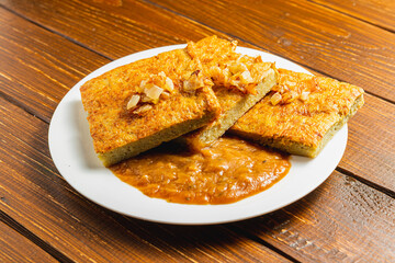 Oven-baked potato pancakes with mushroom sauce and onions