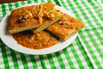 potato pancakes baked in the oven, with mushroom sauce, onions on a green napkin