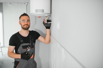 Professional plumber servicing a boiler