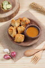 batagor,is a street food that is very popular in Indonesia.made from fish, tapioca and seasoning wrapped in dumplings then fried. Served with spicy peanut sauce. photographed with studio light