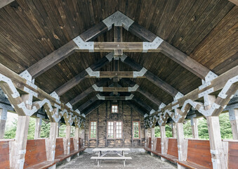 view of a picnic area with a wooden roof and open windows open to public