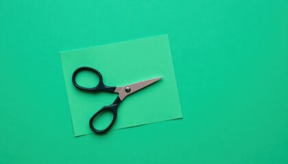 a close up of a pair of scissors on a green surface,
