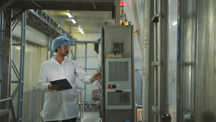 The production control supervisor inspects and controls the operation of machines in the manufacturing line of a canned fish industry