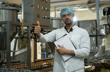 Portrait of production control supervisor inspects and controls the operation of each step in the...
