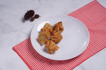 batagor,is a street food that is very popular in Indonesia.made from fish, tapioca and seasoning wrapped in dumplings then fried. photographed with studio light