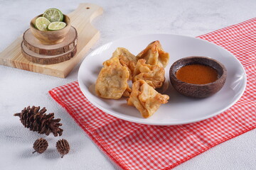 batagor,is a street food that is very popular in Indonesia.made from fish, tapioca and seasoning wrapped in dumplings then fried. Served with spicy peanut sauce. photographed with studio light