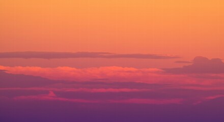 Fototapeta premium Sunset Cloudscape: A breathtaking panorama of clouds illuminated by the fiery hues of a setting sun, creating a dramatic and awe-inspiring scene. 