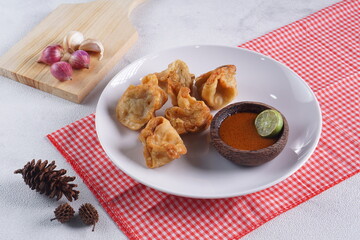 batagor,is a street food that is very popular in Indonesia.made from fish, tapioca and seasoning wrapped in dumplings then fried. Served with spicy peanut sauce. photographed with studio light