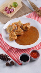 batagor,is a street food that is very popular in Indonesia.made from fish, tapioca and seasoning wrapped in dumplings then fried. Served with spicy peanut sauce. photographed with studio light