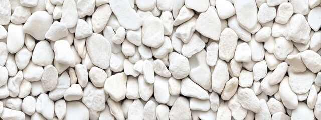 Close-up of many smooth, off-white pebbles.