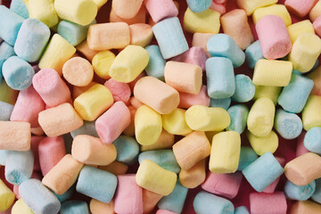 Confectionery and sweeties varieties background: light pink and white marshmallows, sugar confetti, bonbon and candies, selective focus, shallow focus