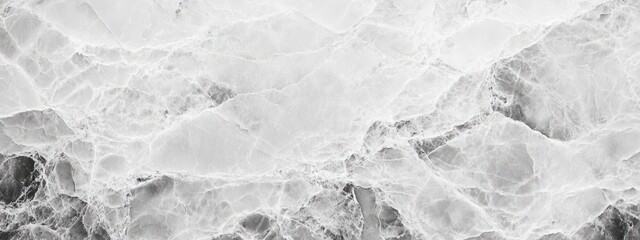 Abstract grayscale image of textured surface resembling stone or ice.