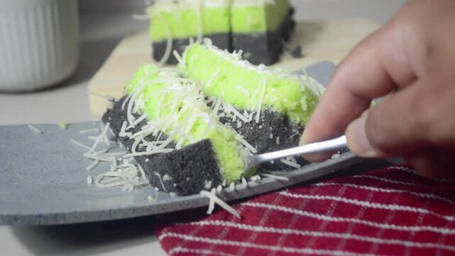 Take a piece of pandan sponge cake with a fork. The concept of food tasting