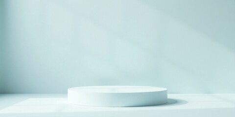 Minimalist White Cylinder Platform Against Pale Blue Wall, Ideal for Product Presentation or Showcase