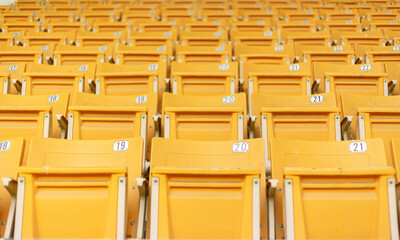 Fototapeta premium Empty stadium seats, anticipation, upcoming game, sports arena, no spectators, colorful seats, bleachers, grandstand, field view, before the match
