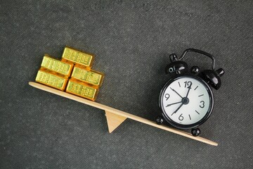 The balance between time and gold represents the trade-off between wealth and time management. It highlights the value of time as an irreplaceable resource, often compared to gold, which symbolizes 
