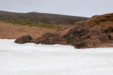 Drangsnes Iceland, patch of meting snow in meadow