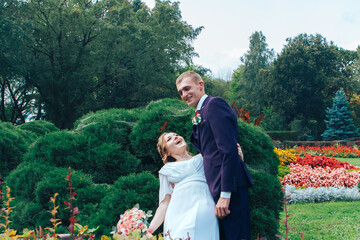 Loving newlyweds in festive clothes after the ceremony walk in nature