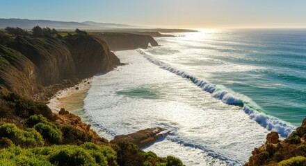 Obraz premium Stunning coastal cliffs with waves crashing against shore under bright sky