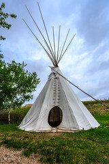 A teepee is standing in a grassy field © Scott Prokop