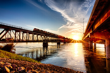 A bridge spans a river with a train crossing it