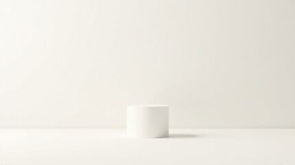 A simple white cylindrical pedestal against a minimalist white backdrop, perfect for showcasing products or artwork in a clean and modern setting.