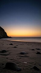 Serene beach at dusk with gentle waves and starry sky in the background.