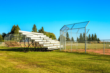 Fototapeta premium A baseball field with a fence and bleachers
