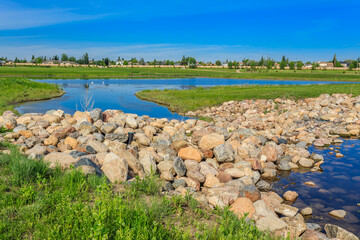 A rocky shoreline with a body of water in the background