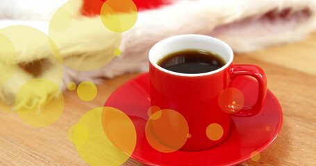 Image of yellow dots over red cup of coffee