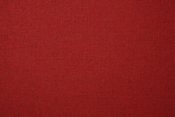 a close up of a red cloth with a small hole in the middle