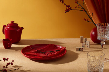 Luxury new year decoration table photograph was taken from high angle. Twinkle golden table contains some Tet-themed decorative items and a blank dish in center for product featuring