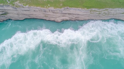 Aerial View of Powerful River Rapids Crashing Against Cliff