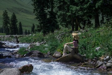 Exploring Xinjiang Tangbra Scenic Area with the tranquil Mengket Ancient Road beside a flowing river