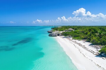 Aerial view of pristine beach, turquoise water, and lush vegetation.