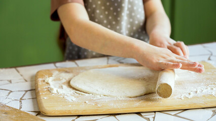 Rolling out dough with a wooden pin