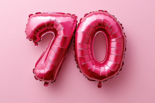 Pink balloons with the number 10 floating outdoors, celebrating a special occasion.