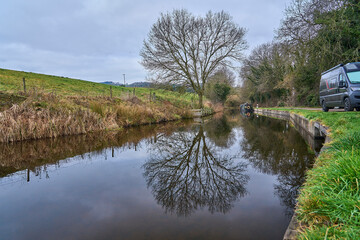 moored narrow canal boats on river Dee near the Pontcysyllte Aqueduct in Wales.