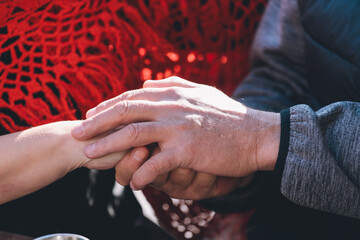 A close-up view of a person grasping another person's hand, conveying intimacy and connection.