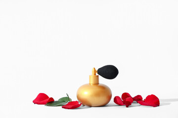 Bottle of perfume with rose petals on white background. Valentine's day celebration