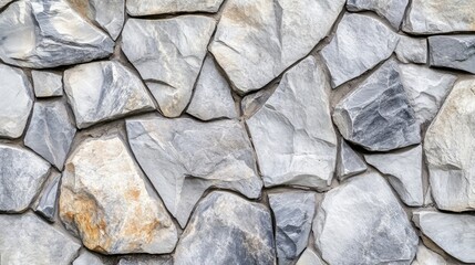 Textured gray stone wall background with irregularly shaped stones creating a natural and rustic appearance for architectural designs.