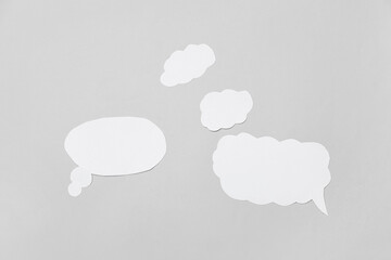 Set of blank paper speech bubbles on grey background