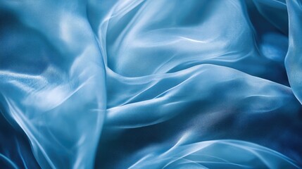 Obraz premium Flowing blue fabric texture reminiscent of water waves creating a serene and tranquil background suitable for various artistic applications.